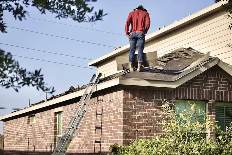 Professional roofer working on a residential roof in Italian Lake